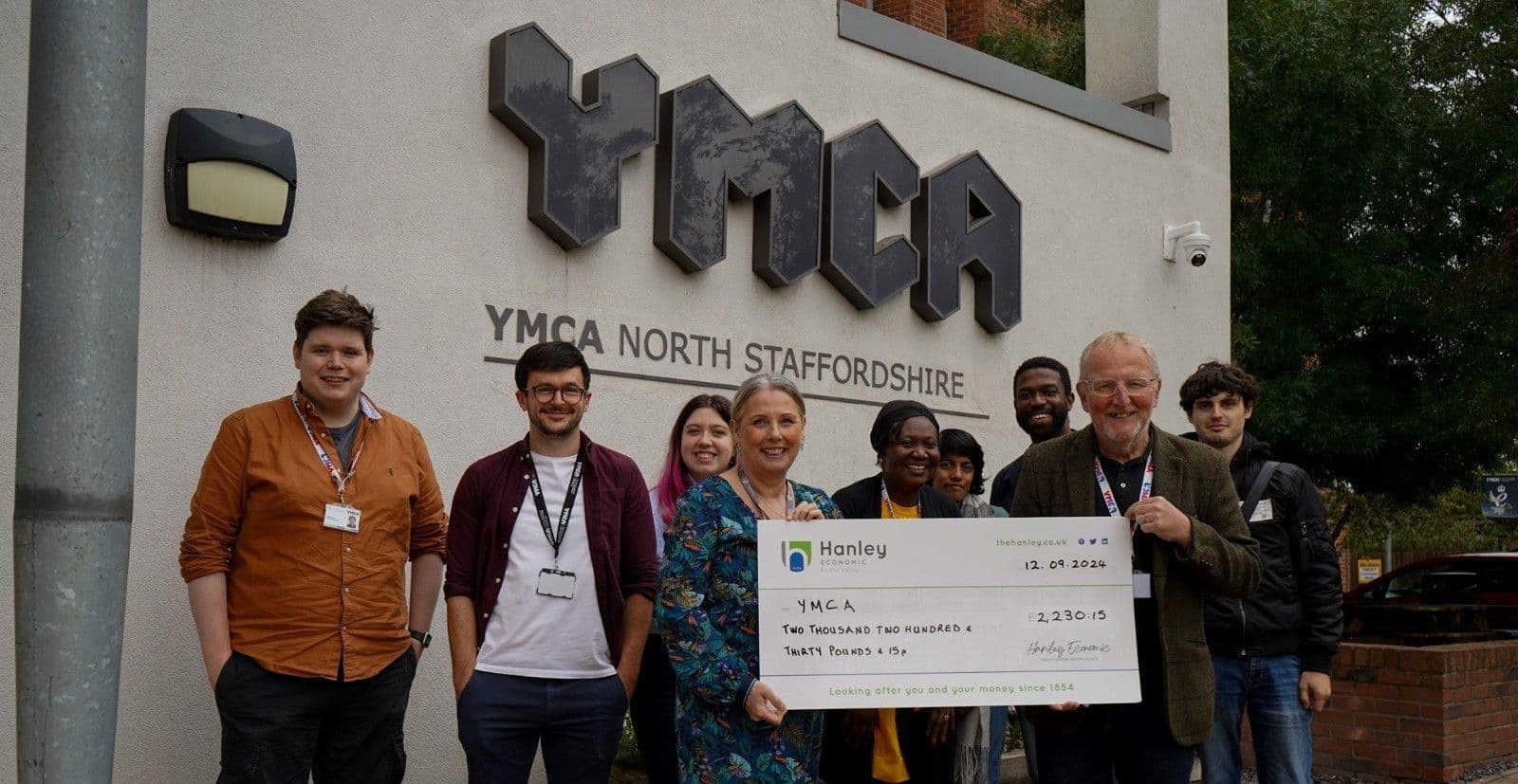 Hanley Economic Staff Volunteering and taking a photo outside of YMCA North Staffordshire