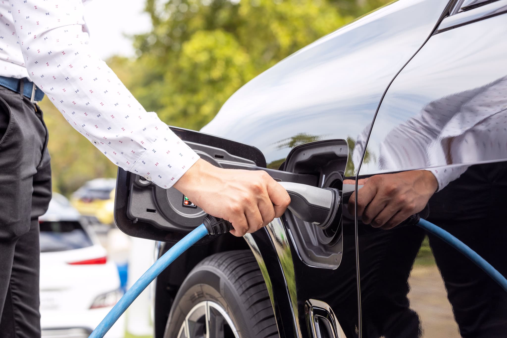 Image of person placing their electric vehicle on charge